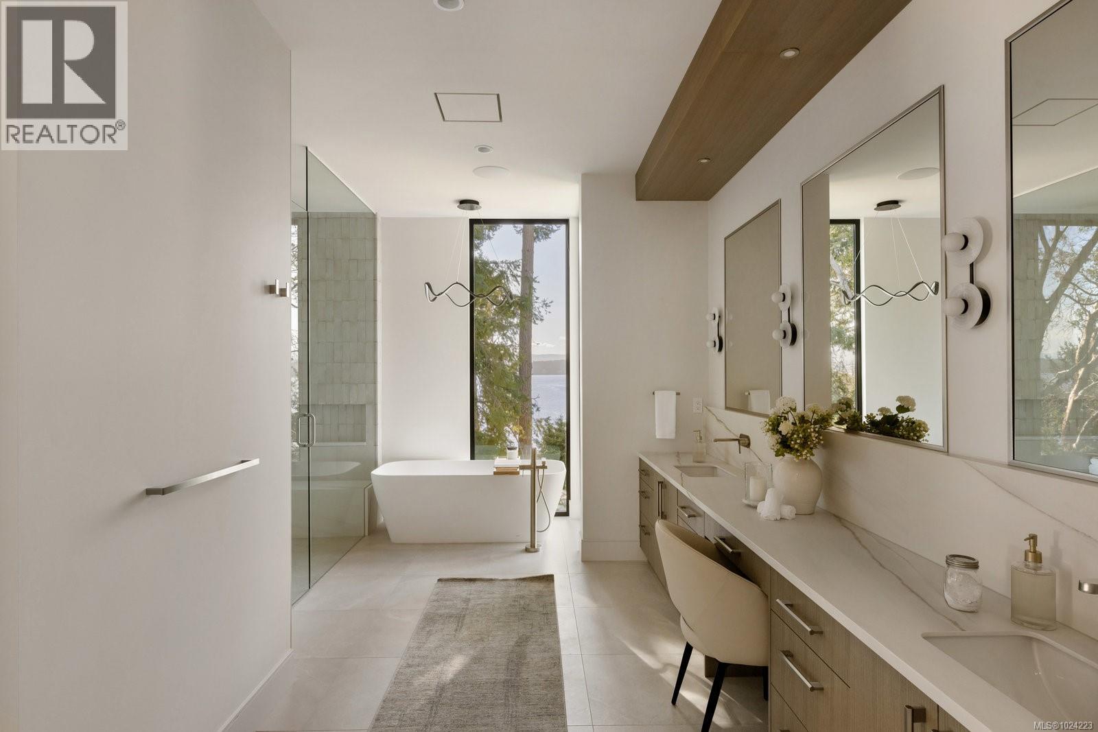 Luxurious spa-like bathroom with freestanding soaker tub, walk-in rain shower and natural stone tile