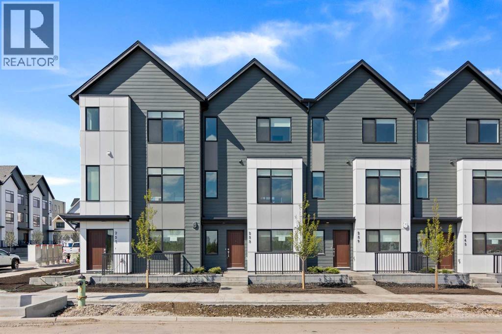 Row / Townhouse for Sale in 132 Quesnay Wood Link SW|Calgary, Alberta T3E8H6