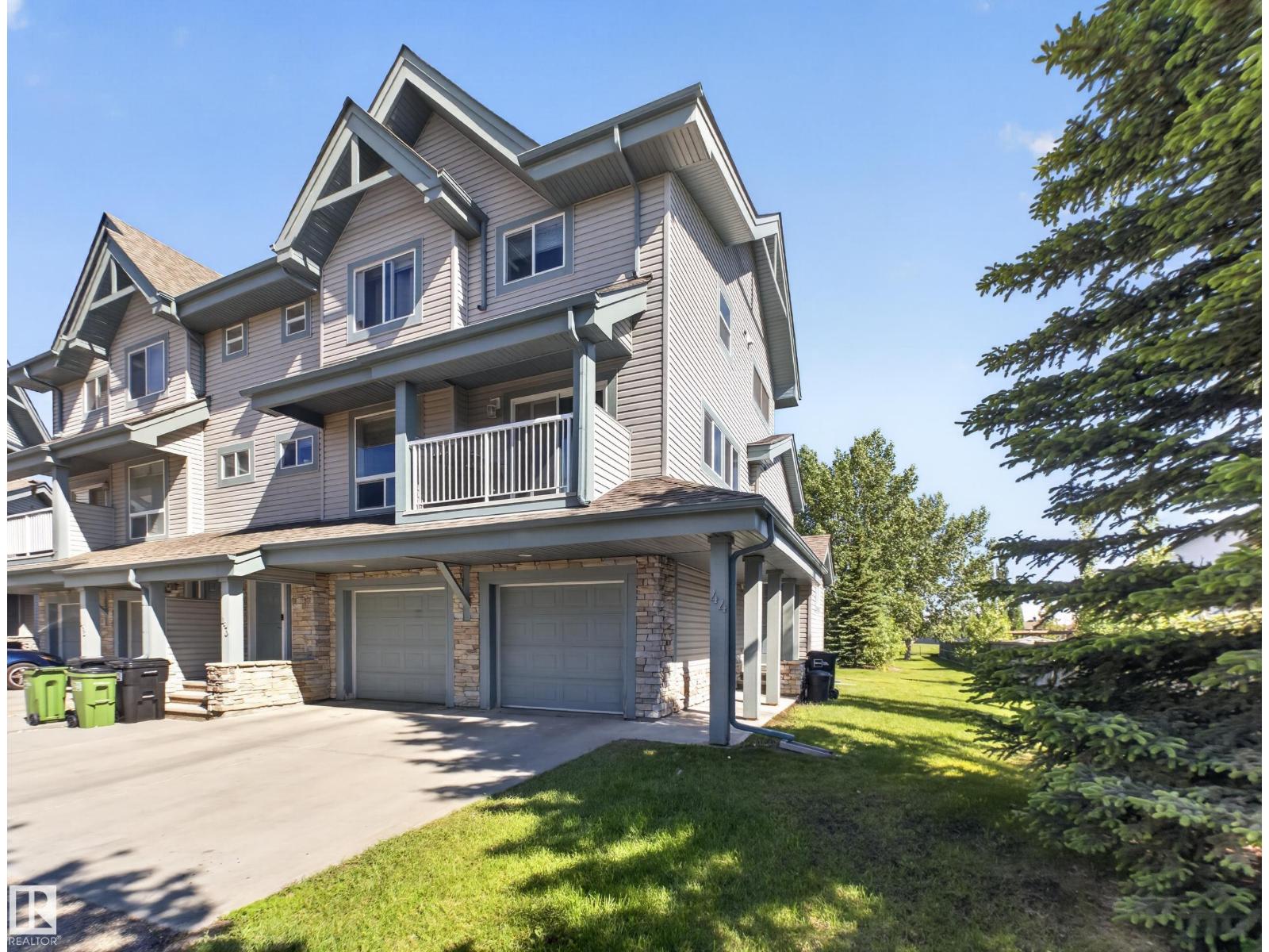 Front exterior — end unit, double-wide driveway, attached garage
