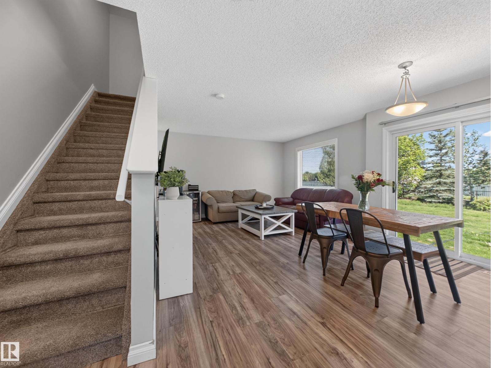 Living and dining open plan with the stairs and patio doors