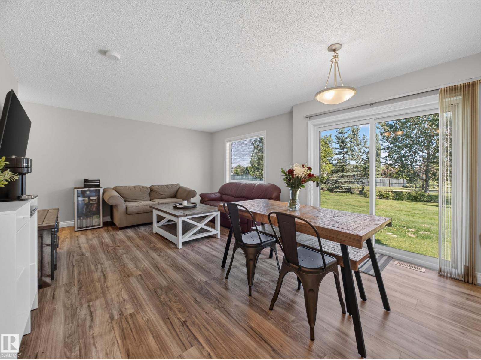 Living room toward the patio door and green belt view