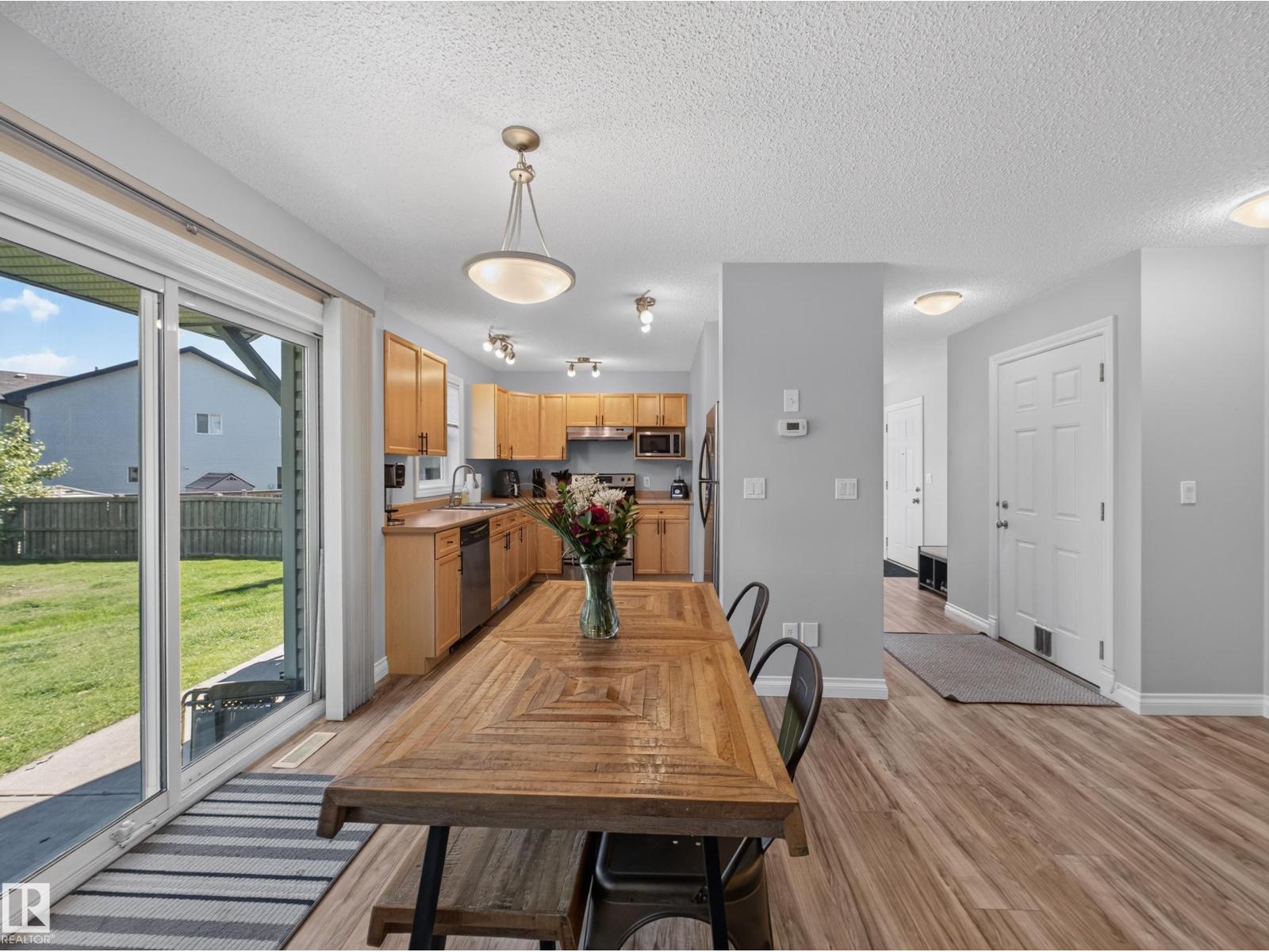 Dining table, kitchen and front entry