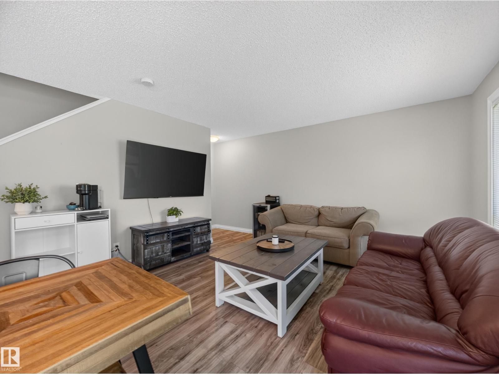 Living room with the TV wall, sectional and coffee table