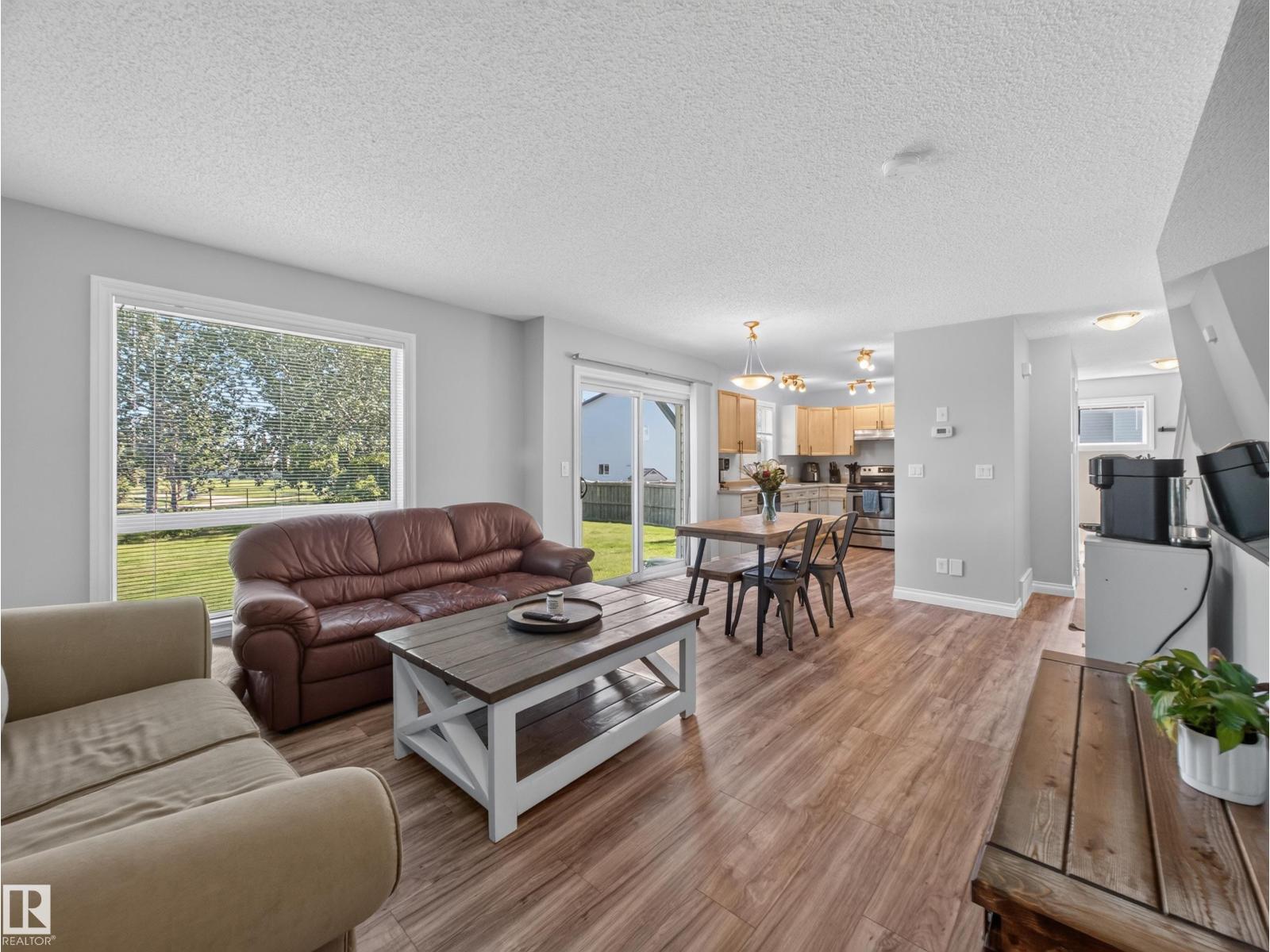 Living room toward the window with the kitchen beyond