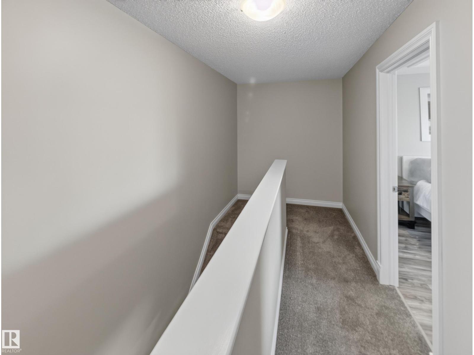 Upper landing with carpet and a bedroom door