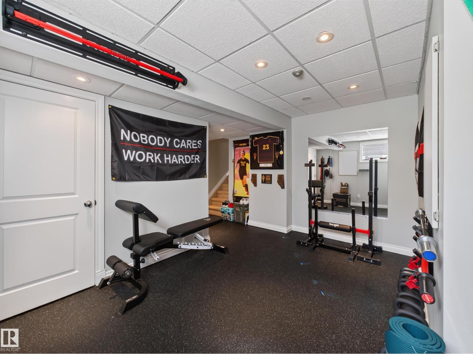 Basement gym with door and mirror