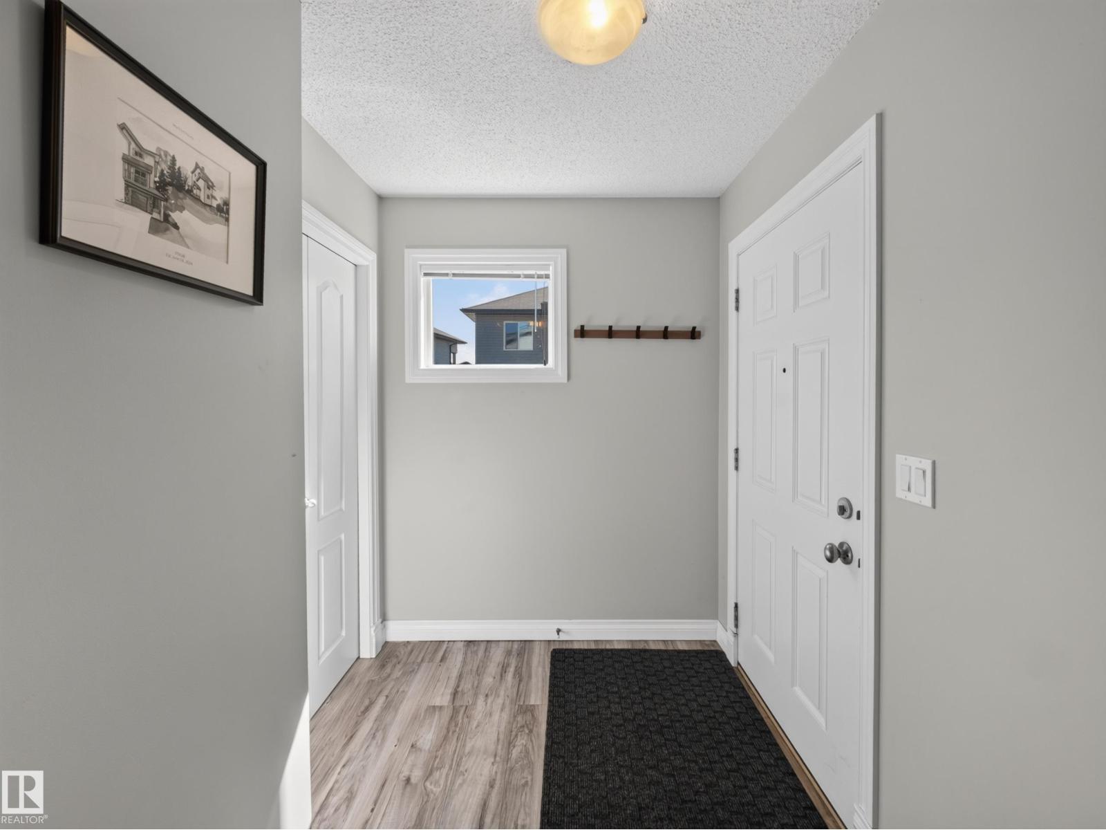 Front entry foyer with coat hooks and window