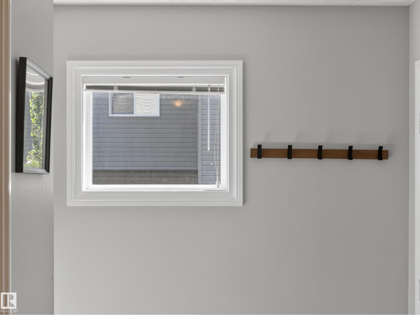 Entry foyer wall with window and coat rack